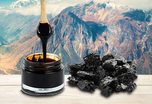 MyHealthKart Ayurveda jar with black Shilajeet resin and a wooden spoon with mountains in background buy shilajeet resin online